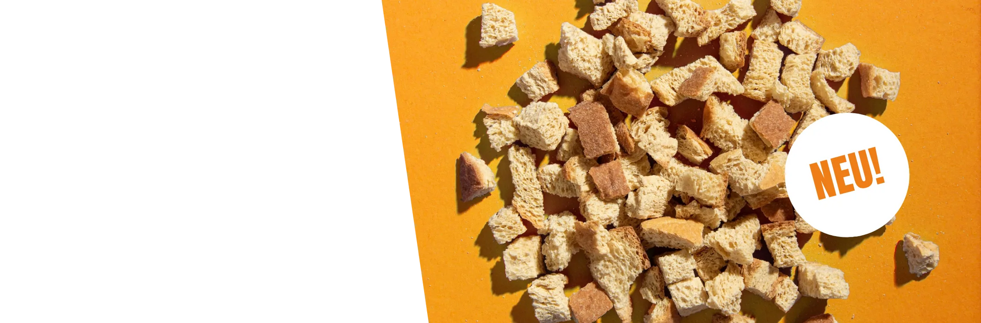 STEINER´s Low Carb High Protein Croutons auf orangenem Untergrund.